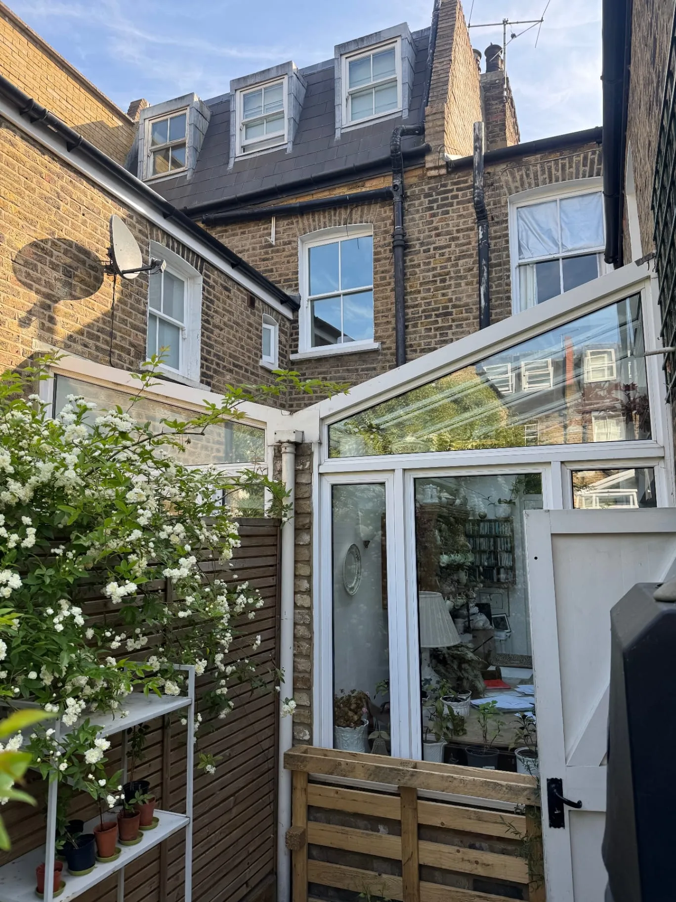 Rear elevation of a Victorian terrace with conservatory and loft conversion, annotated by a builder