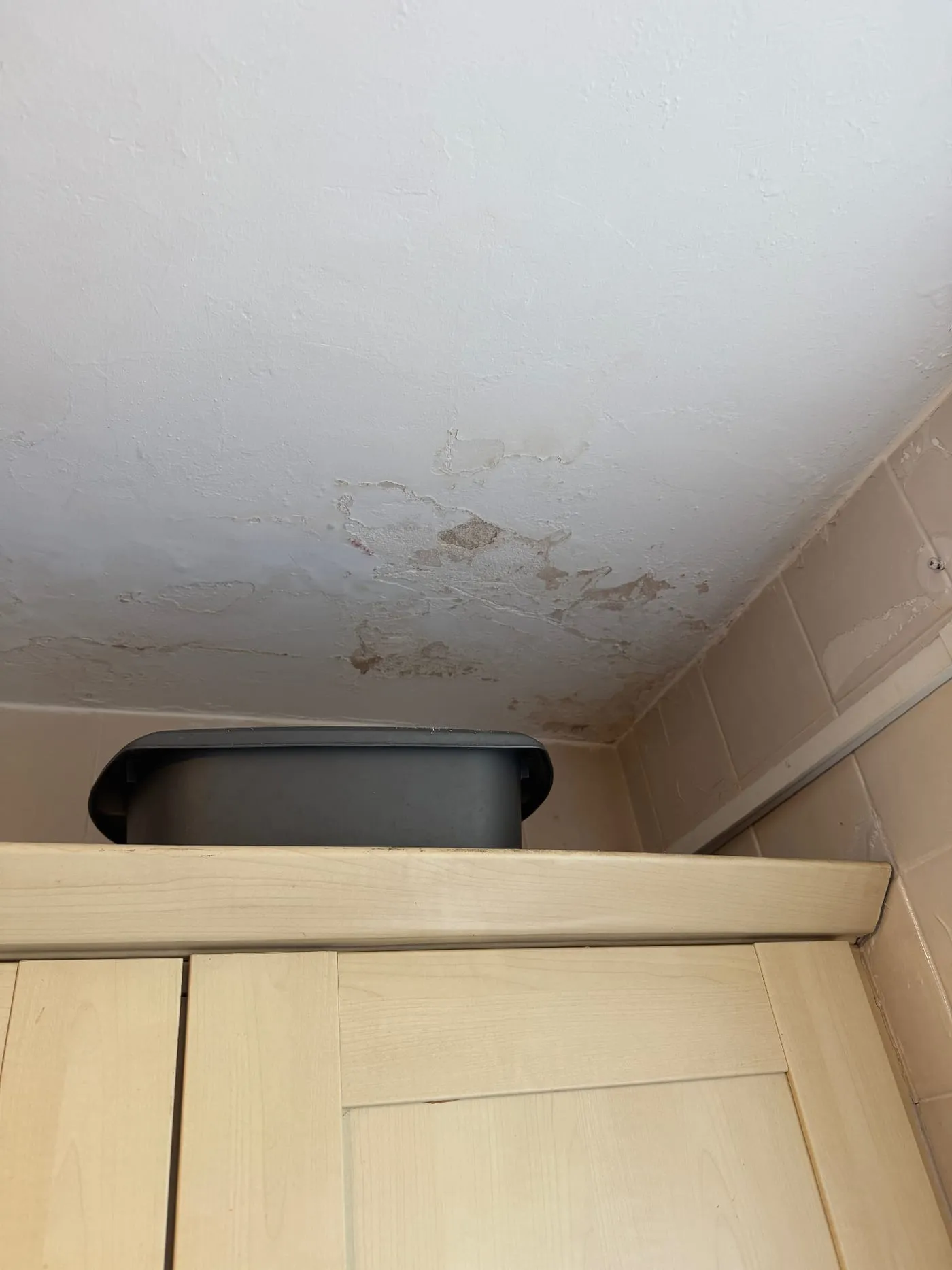 Ceiling damp patch caused by a leak from the bathroom above