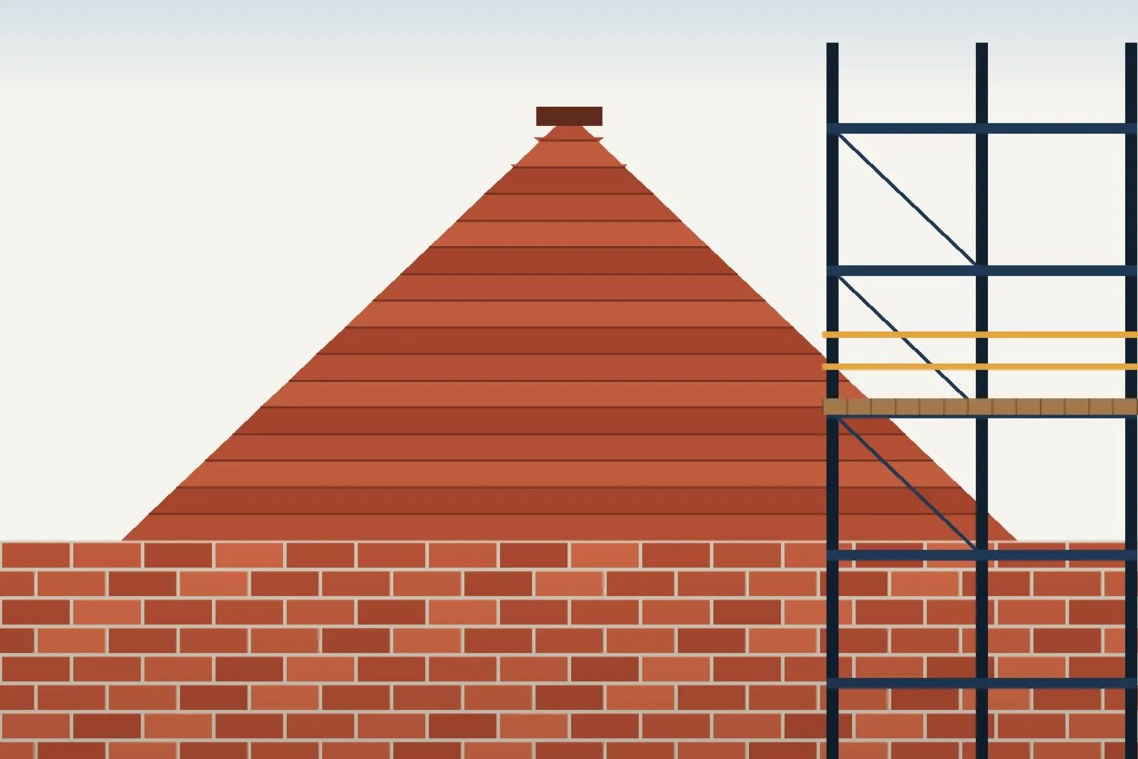 A pitched tiled roof with scaffold erected alongside it, ready for a re-roofing project