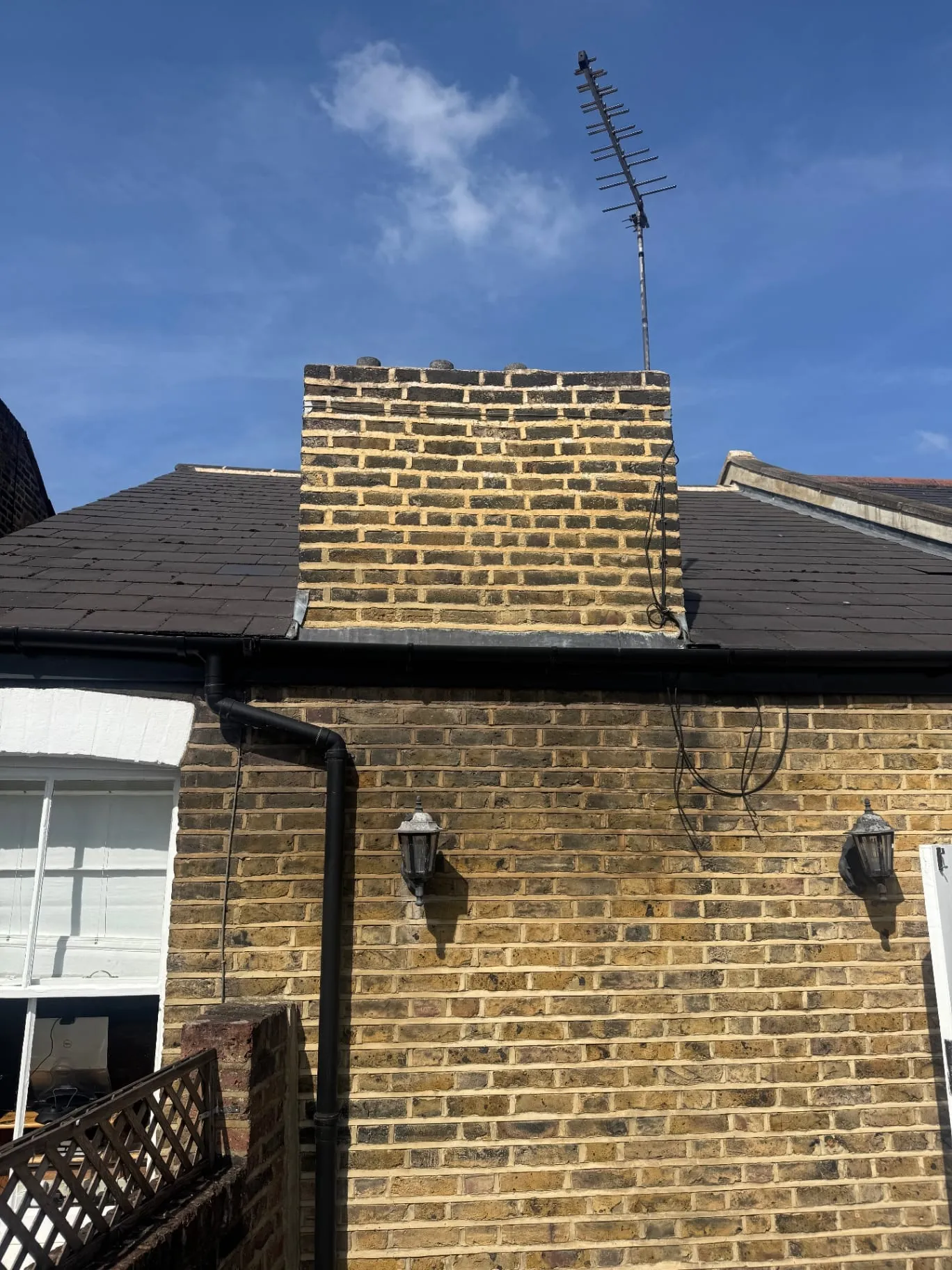 Victorian chimney stack with weathered pointing and flashing